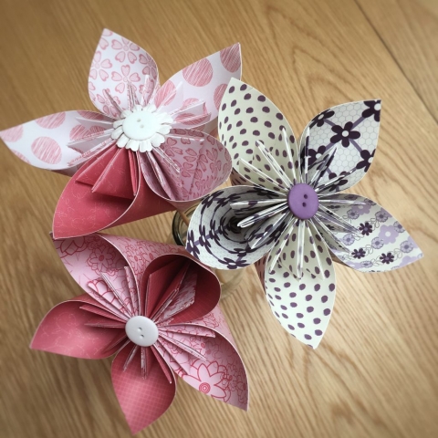 Three large decorative paper kusudama flowers using pink and purple craft papers